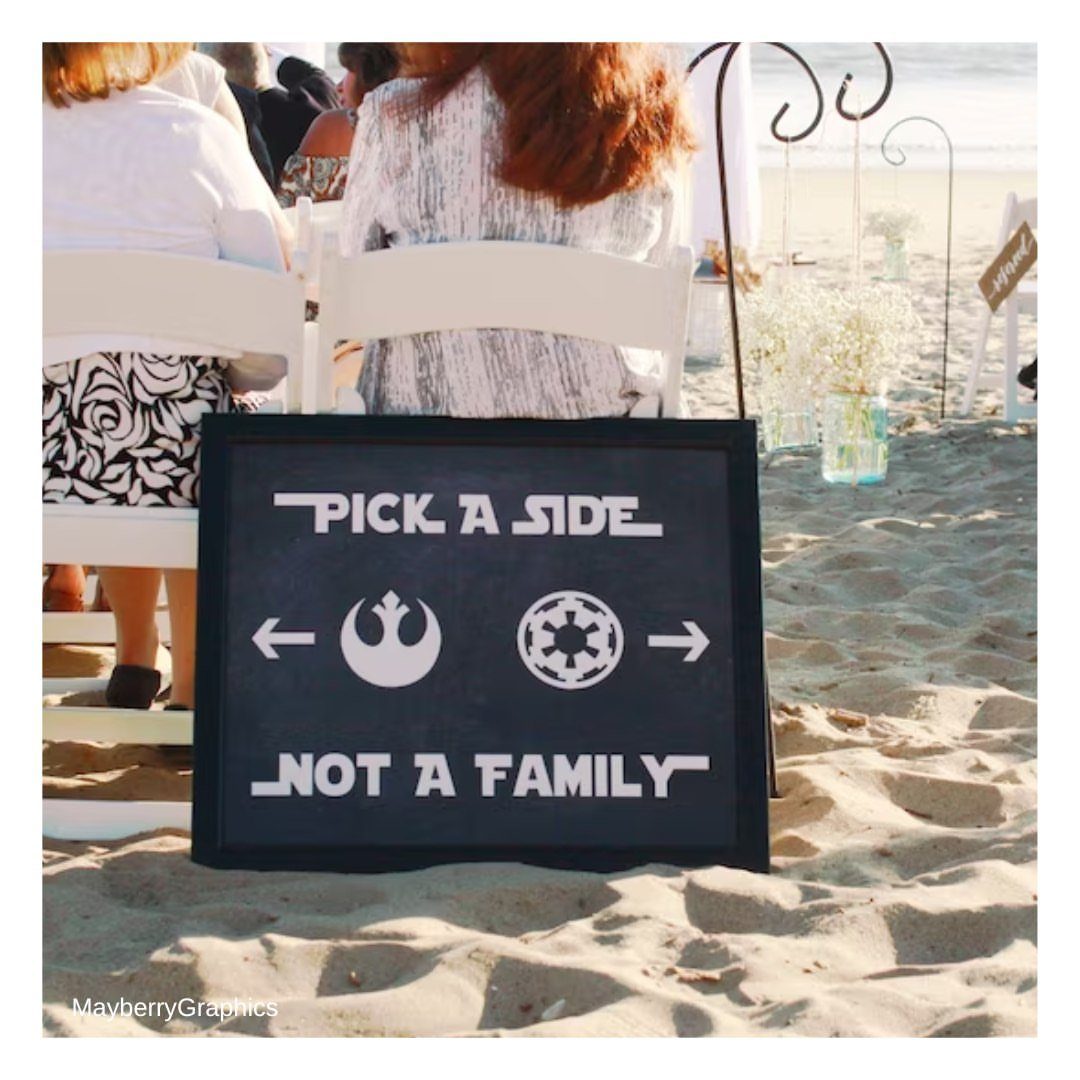Star Wars themed wedding sign on a beach with Rebel and Empire symbols.